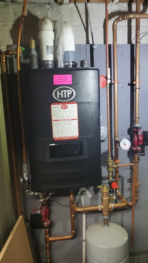 High-efficiency furnace intake and exhaust PVC venting through an exterior wall
