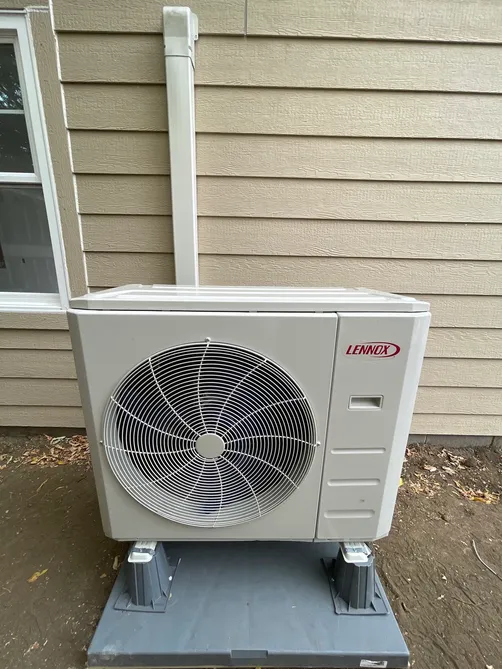 Lennox high-efficiency furnace installed in a closet with new venting