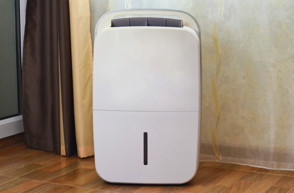 Whole-Home Dehumidifier In St. Louis Park, MN 1 A white air conditioner placed on a polished wooden floor, showcasing its sleek design and modern appearance.
