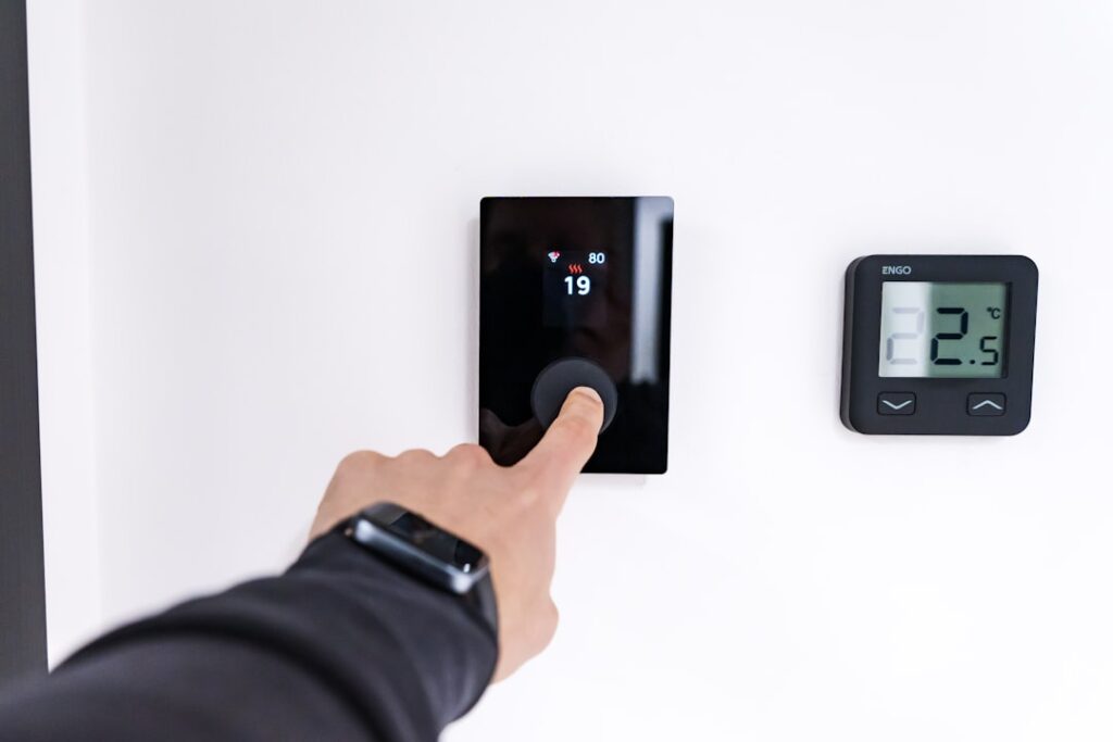 The My House is Still Hot AC Troubleshooting Guide 2 frustrated homeowner checking thermostat in a warm house
